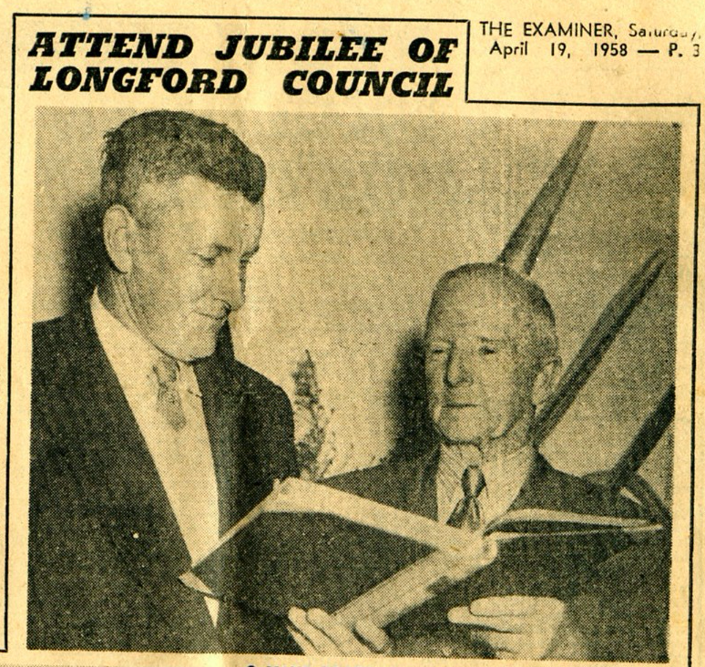 A. F. Richardson (left), who is serving his first term on the council, looks through the visitors book with Mr. G. Cairns, who was a councillor for 27 years and Warden for 16 years.